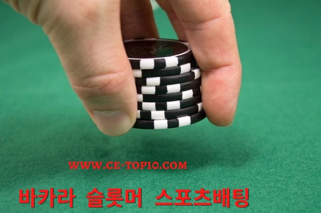 Man placing casino chips on the green table as bet playing live poker