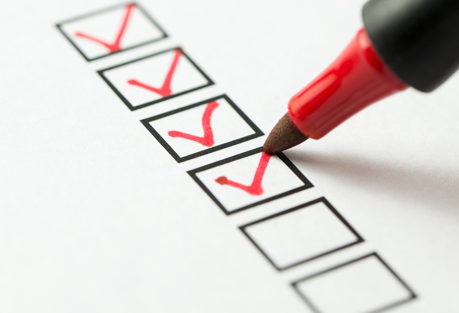 A red pen marking checkboxes of a list.