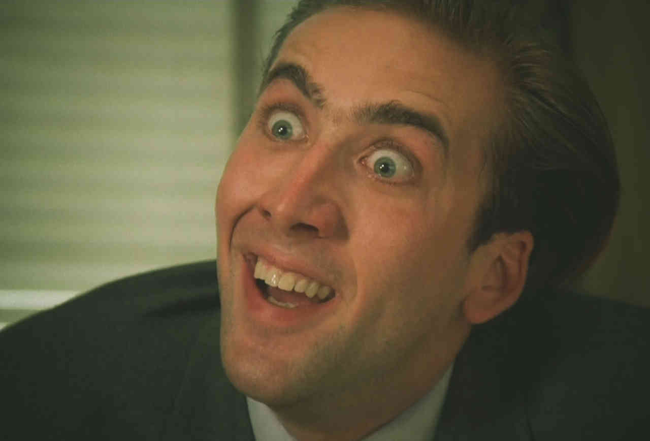 Nicolas Cage with an intensely frustrated expression as he wildly and sarcastically says "Ya don't say!" A meme made from a scene in the 1988 dark comedy film Vampire's Kiss.