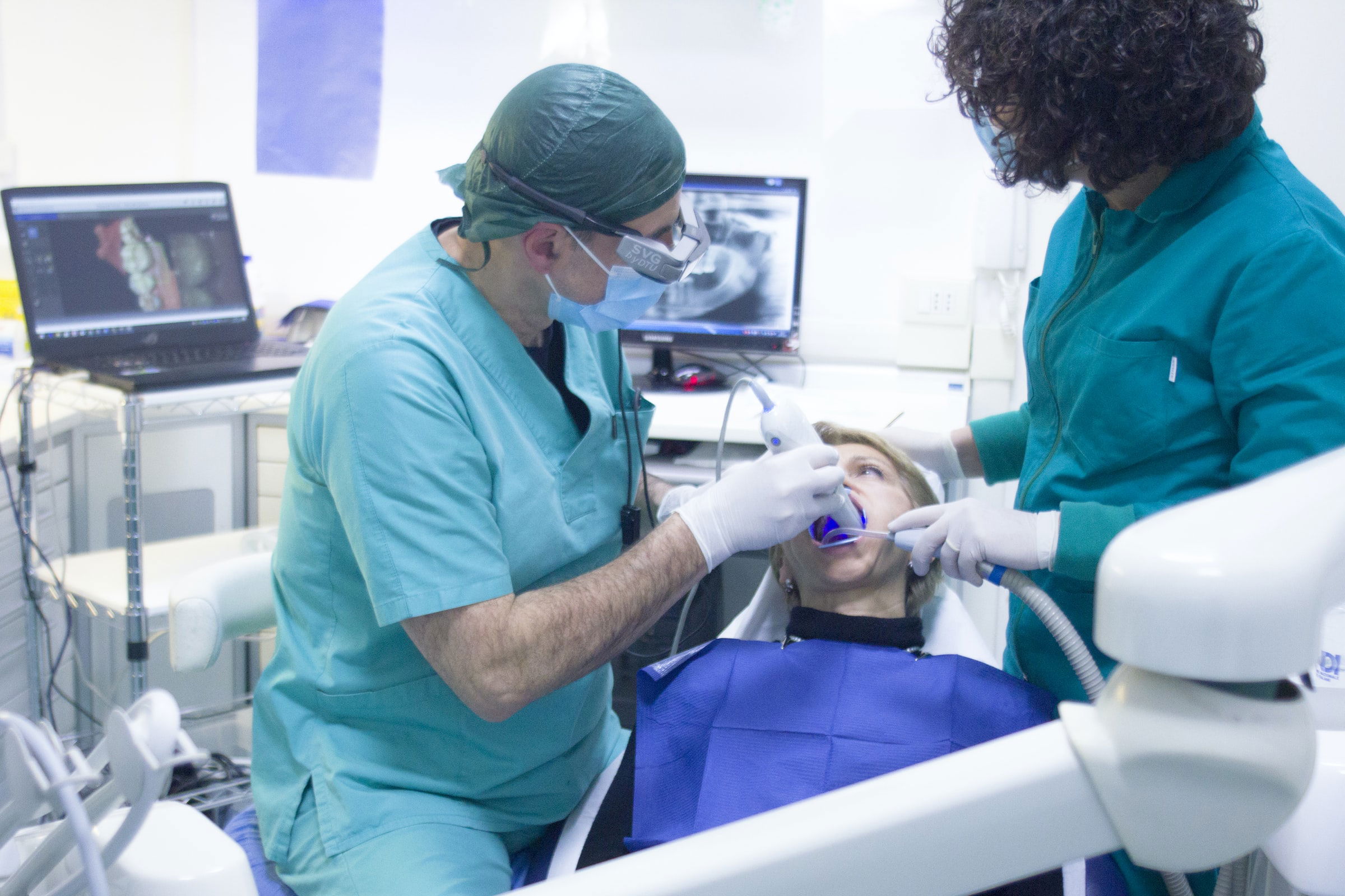 Dentist is checking girl teeth